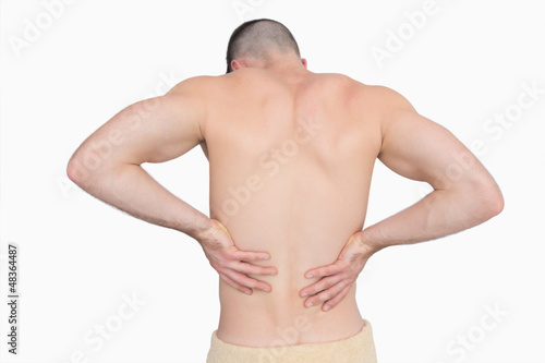 Rear view of shirtless man with back pain