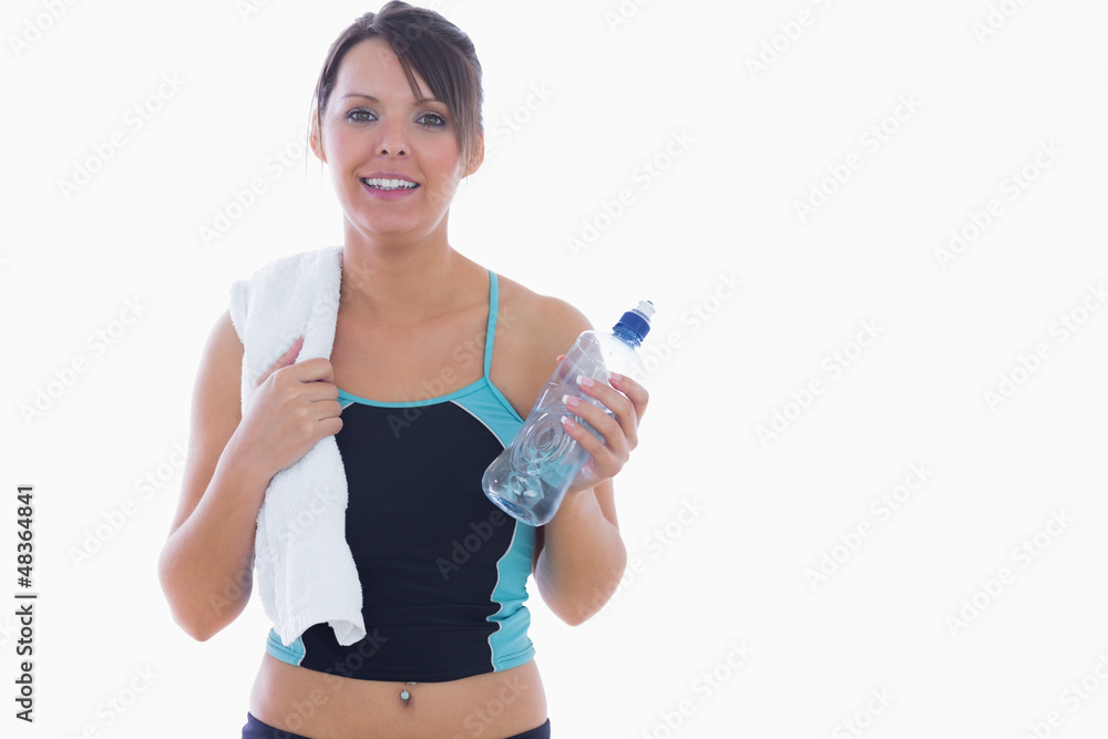 Portrait of woman in sportswear holding towel around neck and wa Portrait of woman in sportswear holding towel around neck and wa
