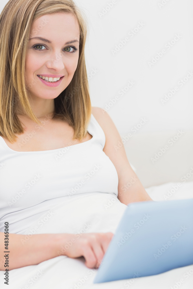 Portrait of woman using digital tablet in bed Portrait of woman using digital tablet in bed