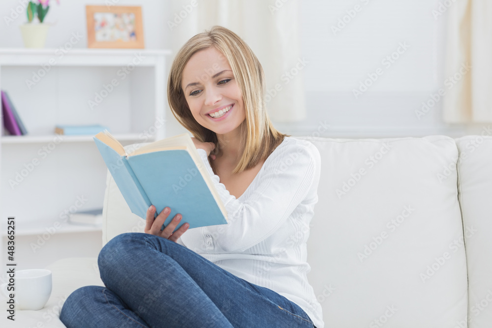Happy woman reading storybook at home Happy woman reading storybook at home