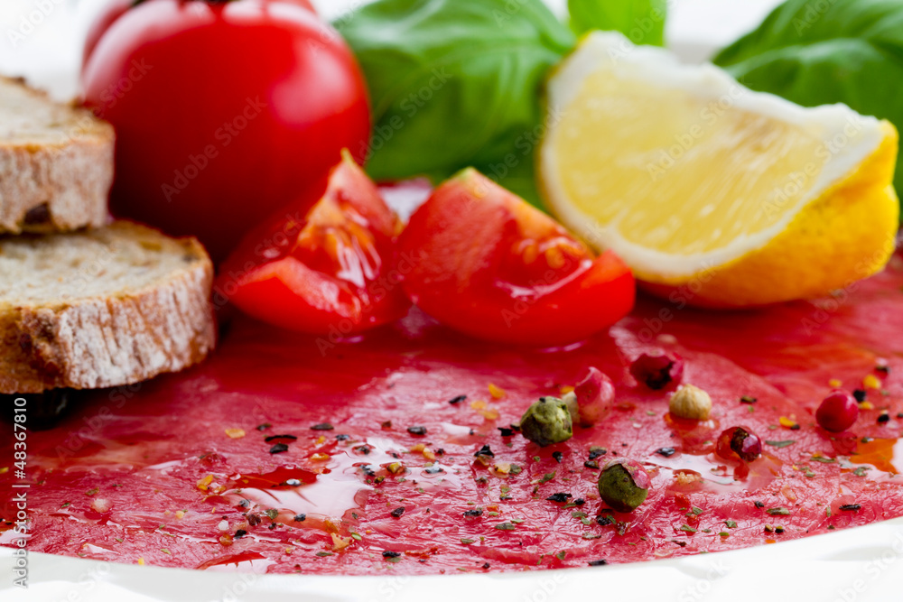 Carpaccio with basil and tomatoes