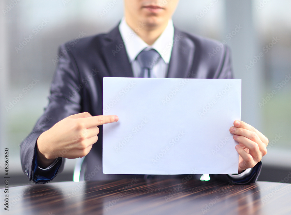 A businessman with a poster to advertise.