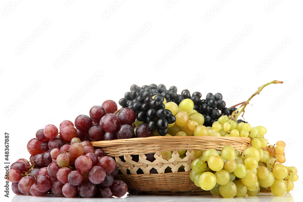 assortment of ripe sweet grapes in basket, isolated on white. assortment of ripe sweet grapes in basket, isolated on white.