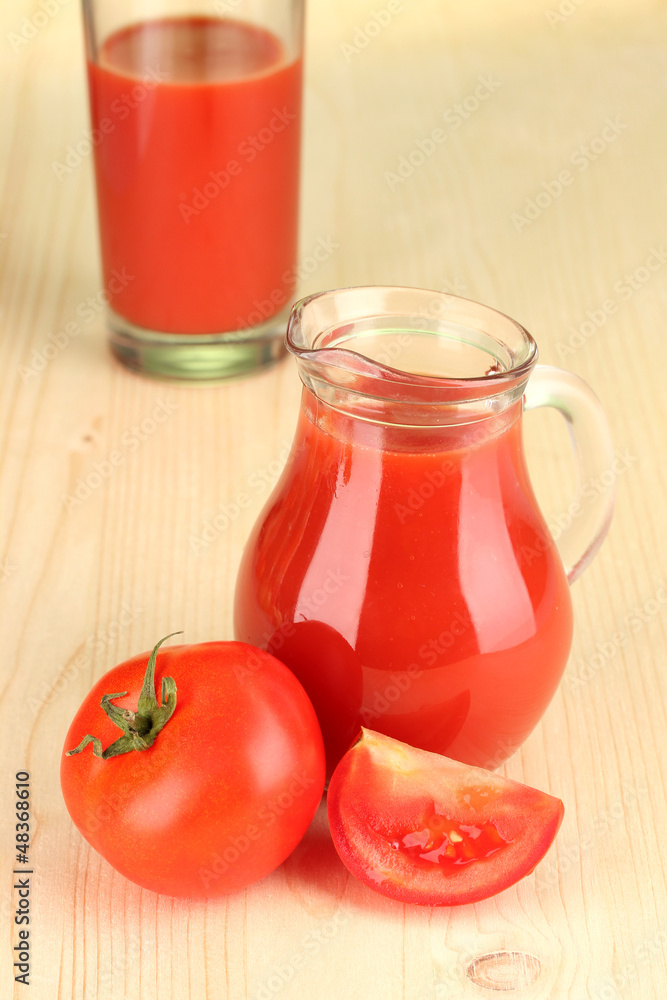 Full jug of tomato juice, on wooden background Full jug of tomato juice, on wooden background