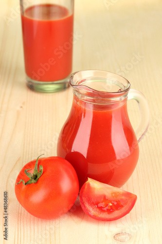 Full jug of tomato juice, on wooden background © Africa Studio