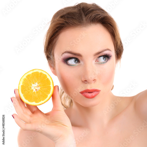 Beautiful young woman with bright make-up, holding orange,