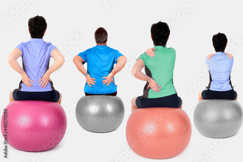 Women and man with exercise ball photo