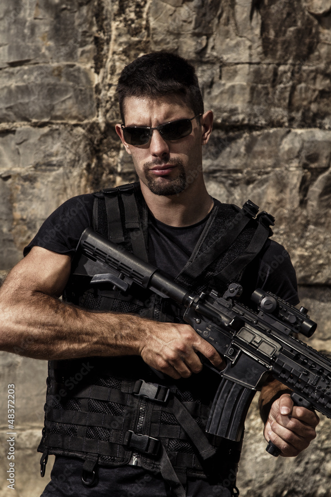 Fototapeta premium menacing man with a machine gun