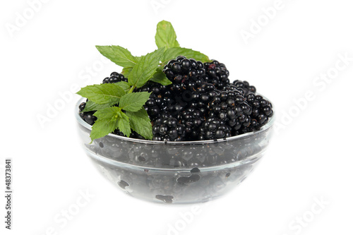 Blackberry with mint leaves in a bowl isolated on white