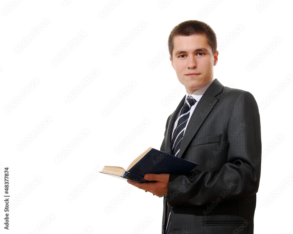 Young businessman in a suit reading a book Young businessman in a suit reading a book
