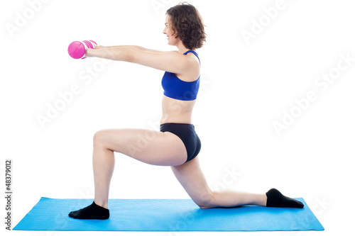 Fototapeta Naklejka Na Ścianę i Meble -  Woman exercising with dumbbells, arms outstretched