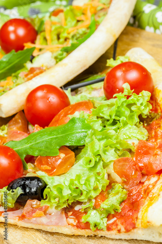 tasty pizza with olives and vegetables on a wooden background