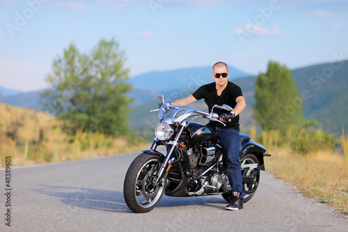 Man posing on a custom made motorcycle