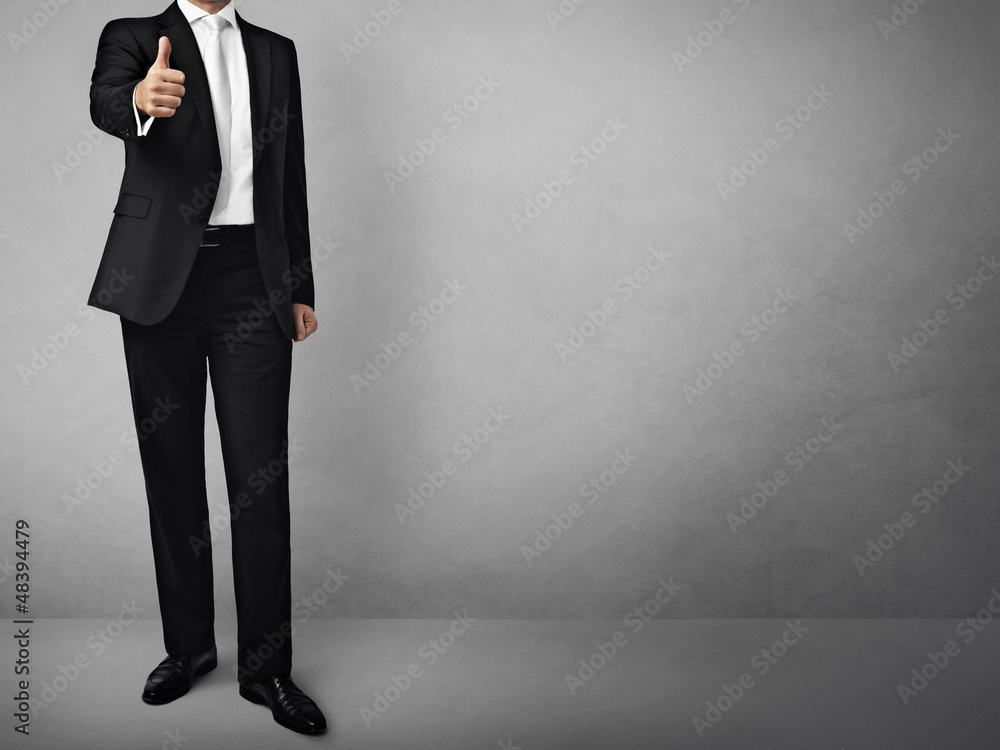 man in suit on a concrete wall background man in suit on a concrete wall background