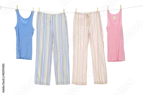 Female shirt and trousers clothespins on rope