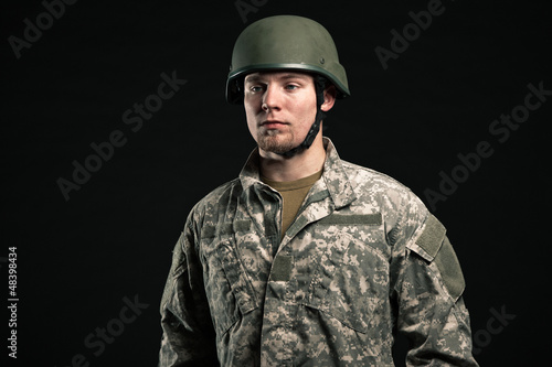 Military young man wearing helmet. Studio portrait. © ysbrandcosijn