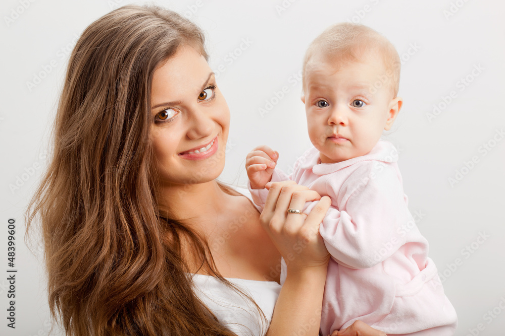 smiling young mother holding her baby girl smiling young mother holding her baby girl