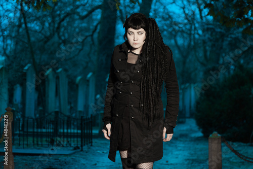 Gothic girl on cemetery.