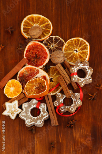 Dried citrus fruits, spices and cookies on wooden table