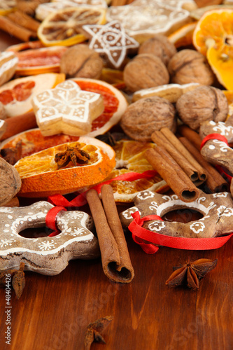 Dried citrus fruits, spices and cookies on wooden table