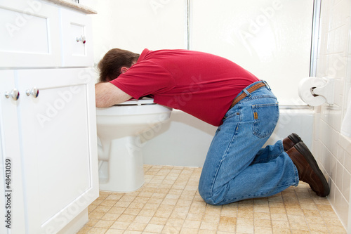 Man Throwing Up in Bathroom