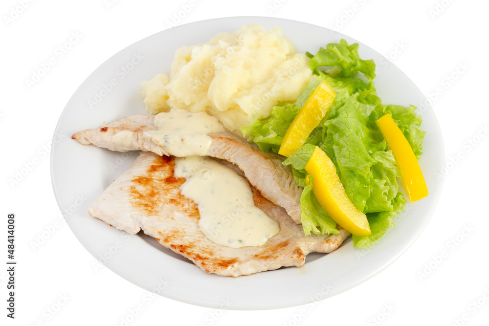 fried turkey with sauce, potato and fresh salad on the plate fried turkey with sauce, potato and fresh salad on the plate