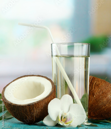 Coconut with glass of milk,  on blue wooden table