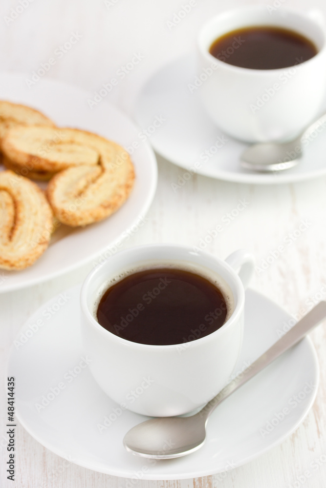 two white cups of coffee with cookies two white cups of coffee with cookies
