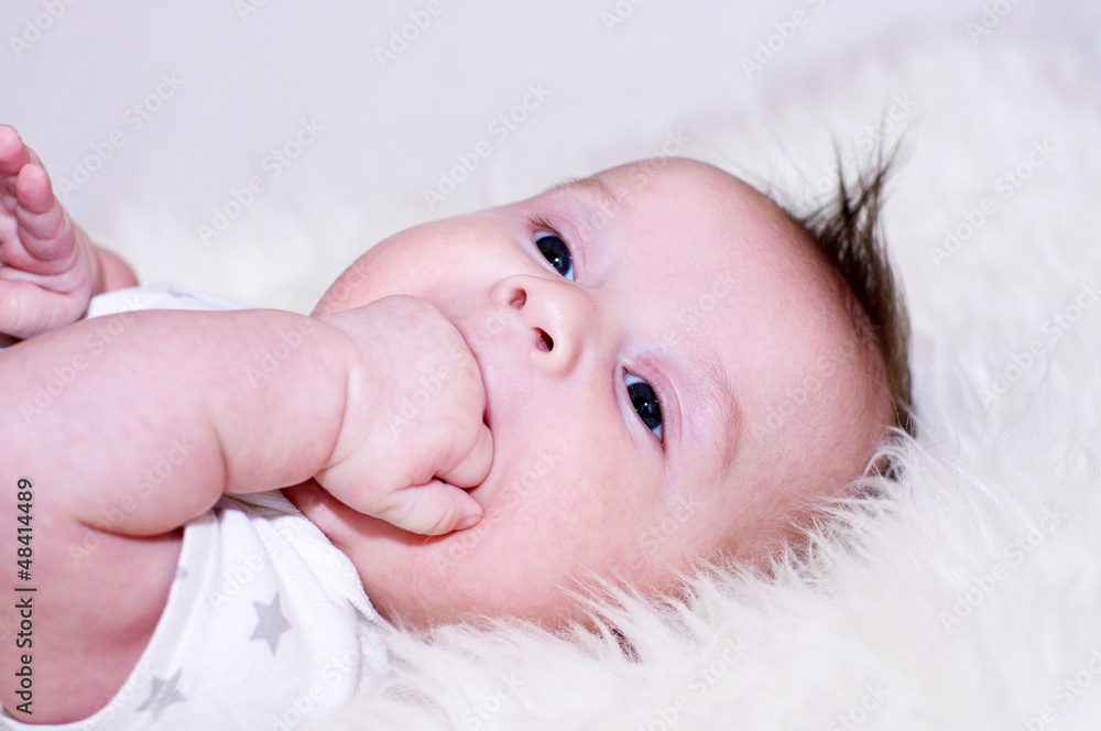 The three-months baby sucks fingers The three-months baby sucks fingers
