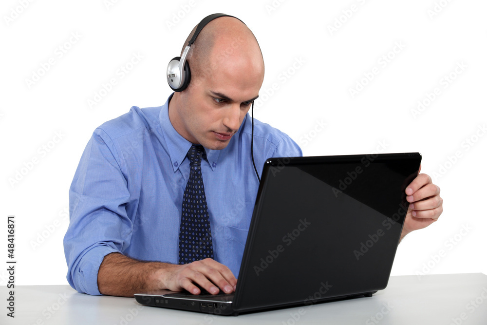 Businessman with a headset and laptop computer Businessman with a headset and laptop computer
