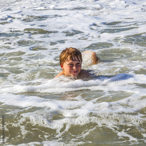 child has fun in the waves © travelview