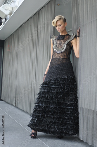 Model wearing couture black dress and gloves