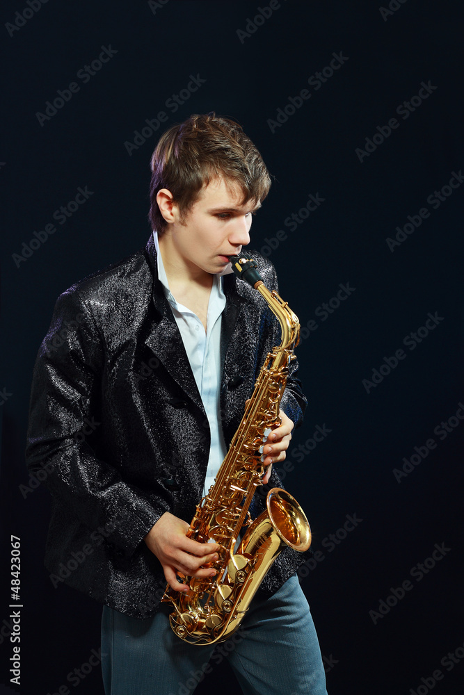 Fototapeta premium young man with saxophone