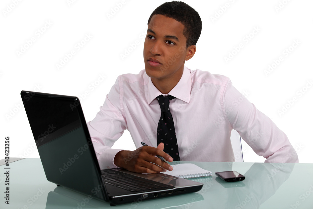 Young man thinking about what to write Young man thinking about what to write