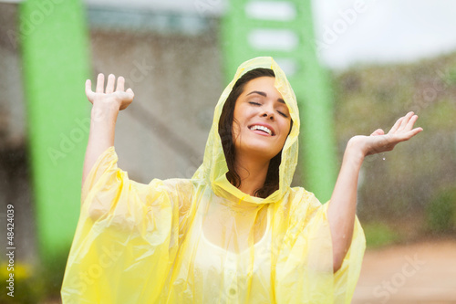 Tela pretty young woman enjoying the rain outdoors