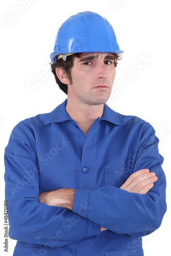 Confused builder with crossed-arms