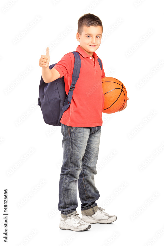 School boy with backpack holding a basketball and giving a thumb School boy with backpack holding a basketball and giving a thumb