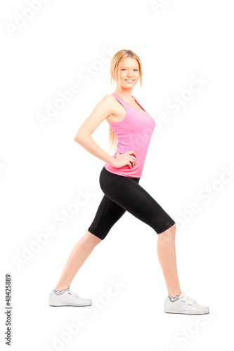 Full length portrait of an active young woman exercising