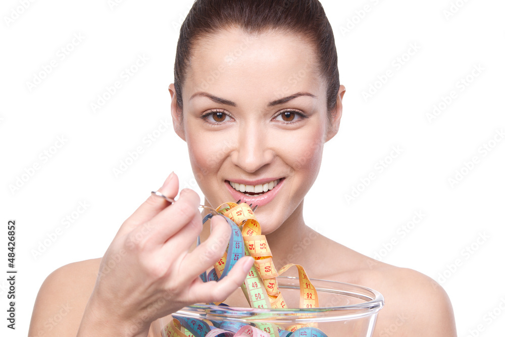Humorous portrait of a young woman keeping a diet and eating mea Humorous portrait of a young woman keeping a diet and eating mea