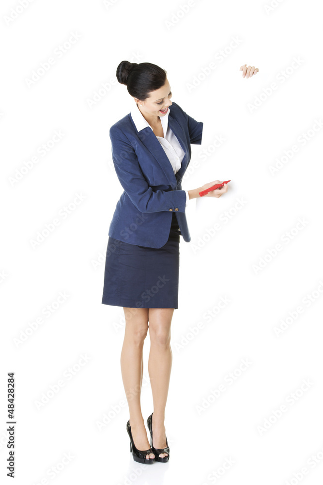 Attractive businesswoman holding blank board Attractive businesswoman holding blank board