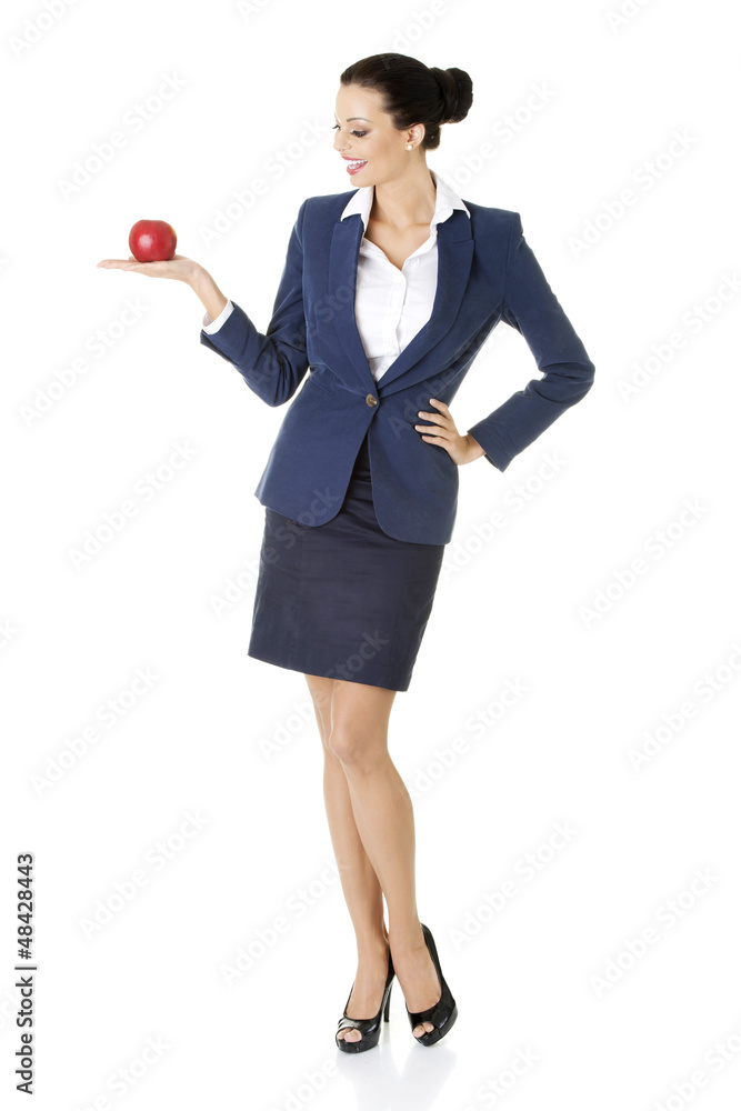 Attractive businesswoman holding red apple Attractive businesswoman holding red apple