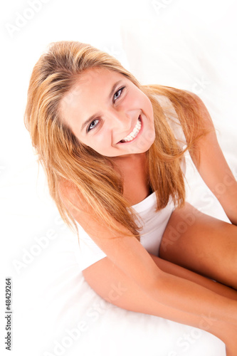 Beautiful blond girl relaxing in bed