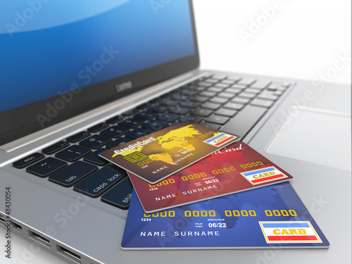 E-commerce. Credit cards on laptop