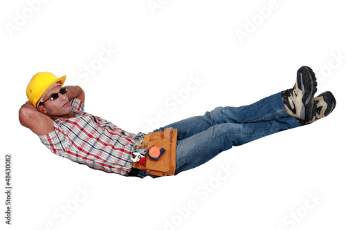 Tradesman lying in an invisible hammock