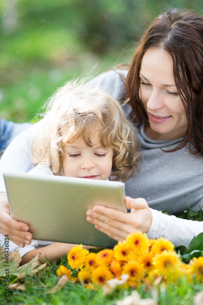Family using tablet PC outdoors