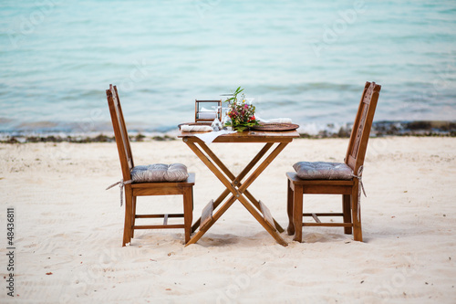 Romantic dinner for two served on a white sand beach © Ekaterina Pokrovsky