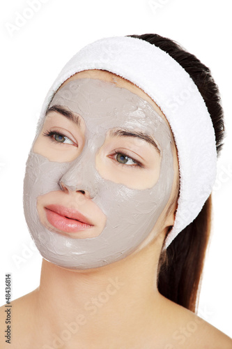 Beautiful woman with clay facial mask