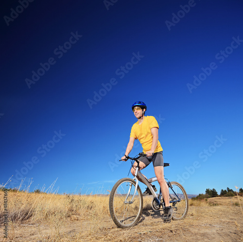 Bicycle rider riding a bike outdoors on a sunny day