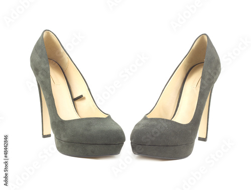 Two beautiful female suede shoes with high heel isolated closeup