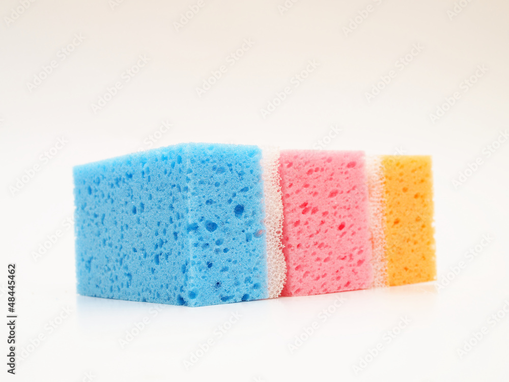 Pink, blue and orange sponge, isolated towards white background Pink, blue and orange sponge, isolated towards white background